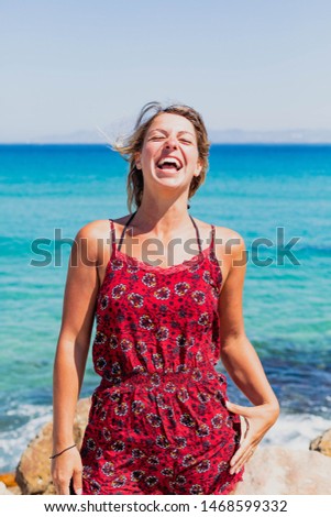 Portrait Photography. A caucasian Blonde woman outdoors in her holidays with an ocean background in her holidays