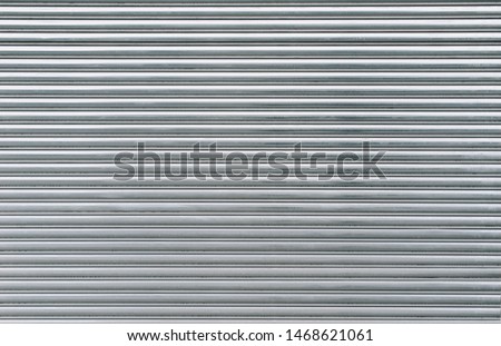 Gray metal shutters. Background of horizontal galvanized sheet metal texture. Royalty-Free Stock Photo #1468621061