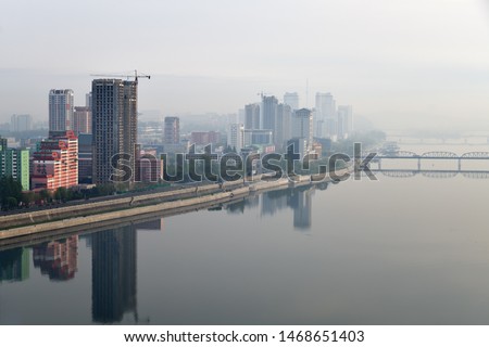 Skyline and Taedong River in the morning fog. View from the Yanggakdo island Royalty-Free Stock Photo #1468651403