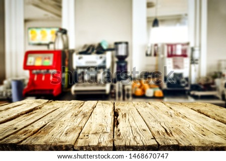 Wooden table background with blurred bar view. Empty space for products and decoration.
