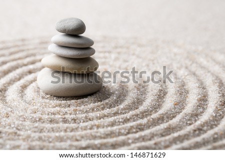 Japanese zen garden meditation stone for concentration and relaxation sand and rock for harmony and balance in pure simplicity - macro lens shot Royalty-Free Stock Photo #146871629