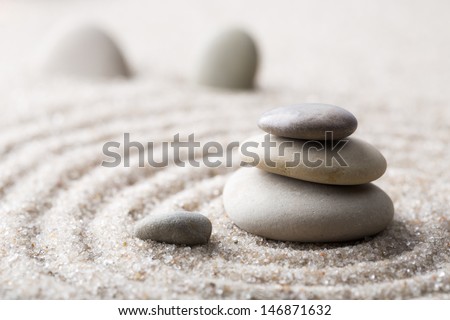 Japanese zen garden meditation stone for concentration and relaxation sand and rock for harmony and balance in pure simplicity - macro lens shot Royalty-Free Stock Photo #146871632
