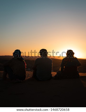 A silhouette of a family in the Sahara desert, Morocco