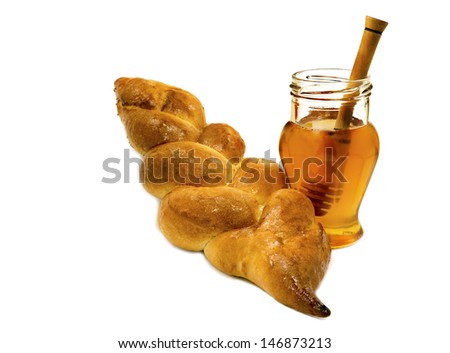 Loaf of challah bread and jar with honey isolated on white background