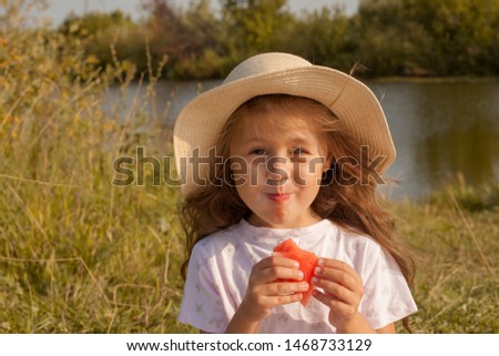Little girl eating watermelon at a picnic