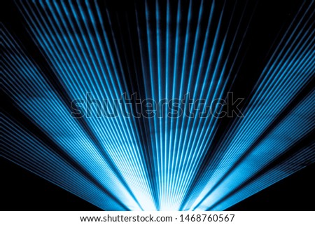 Blue laser show nightlife club stage and shining sparkling rays. Luxury entertainment in nightclub event, festival, concert or New Years Eve. Ray beams are symbol for science and universe research Royalty-Free Stock Photo #1468760567