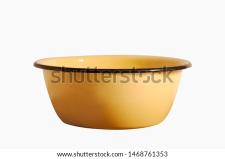 Enameled bowl of yellow color isolated on a white background. The old Soviet dishes. Royalty-Free Stock Photo #1468761353