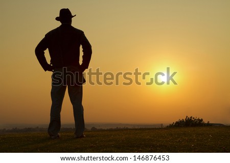 Portrait of a Cowboy Gazing into the sunset Royalty-Free Stock Photo #146876453