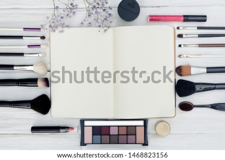 Makeup blank page guide book with a copy space on yellow wooden table background.