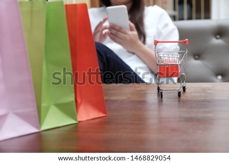 Woman shopping cart with Laptop for Internet online shopping concept.