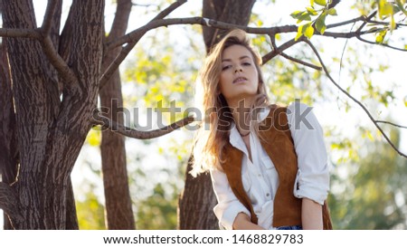 Cute charming girl in summer in the field. Young woman is happy and feels free, outdoors