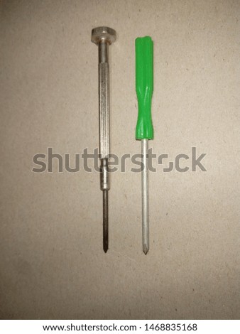 two screwdriver ,head screwdriver with green plastic handle and Precision screwdriver ,on gray background Royalty-Free Stock Photo #1468835168