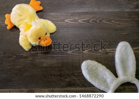 Easter background with bunny ears and yellow ducky with copy space.