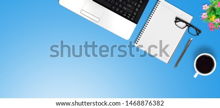 Top view education and office desk with laptop, Coffee, Pen, Flower bouquet, Paper clip, Notebook with copy space background