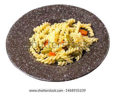 pasta with green beans with garlicand carrots on a brown with a marble crumb  plate isolated on a white background. Mediterranean Kitchen . pasta with vegetables top side  view.