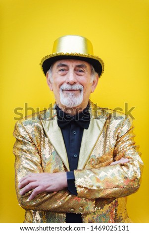 Funny and extravagant senior man posing on colored background - Youthful old man in the sixties having fun and partying Royalty-Free Stock Photo #1469025131