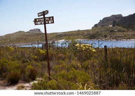 old and rusted direction name sign on top of Table mountain National Park Capetown to skeleton ravine, Wynberg and Constantia nek