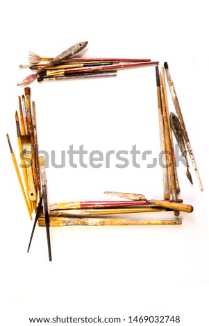 Square frame with paintbrushes (set for artists), various shapes, used, on a white background, isolated, nobody