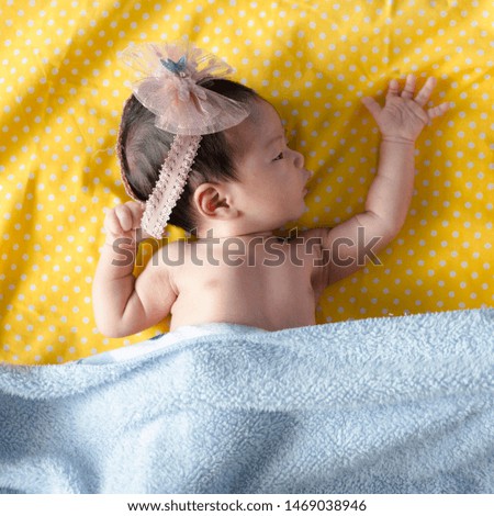 Newborn sleep in a blue blanket Beautiful images of a small girl 2 days, one week