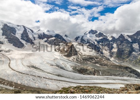 Magnificent view of Mountain Range Diavolezza covered by snow and glacier in the Swiss alps, Engadin, Graubunden, Switzerland, blue sky, white clouds