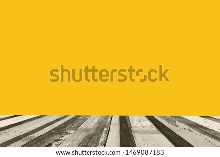 Empty top wooden table on yellow background 