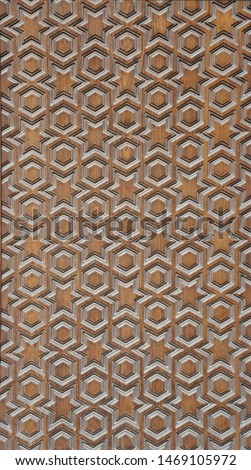 Milled wall panel made of natural wood with a geometric pattern in the form of stars and circles - Arab motifs. Texture of treated wood with 3d effect