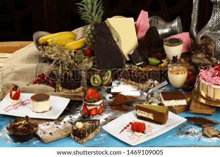 Variety of sweets, desserts and cakes on flours, scoop and sack background