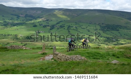 view over the vale of edale with off road cyclists, dark peak district, derbyshire, england, uk Royalty-Free Stock Photo #1469111684