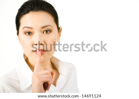 Portrait of businesswoman in white shirt pronouncing shhhh