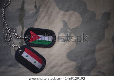 army blank, dog tag with flag of jordan and syria on the khaki texture background. military concept