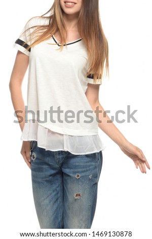 Smiling girl in a white t-shirt and ripped jeans