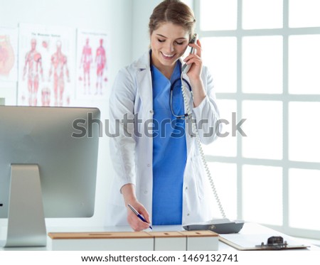 Portrait of a beautiful smiling nurse talking on the phone