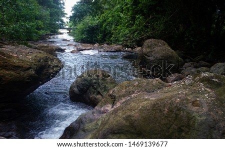 Natural waterfall, shoulder river, through the top of the mountain