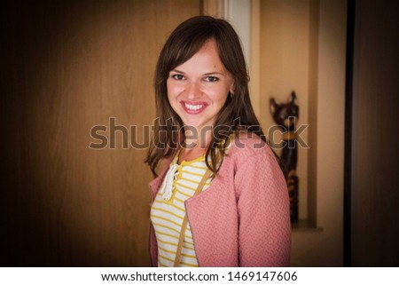 Portrait of young smiling woman at home.