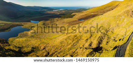 Aerial view of Conor Pass, one of the highest Irish mountain passes served by an asphalted road, located on the south-western end of the Dingle Peninsula, County Kerry, Ireland Royalty-Free Stock Photo #1469150975