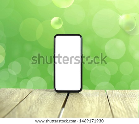 Phone in green background, wood floor