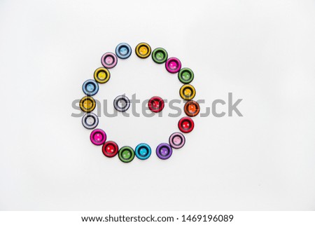 the figure of a button made of multi-colored round buttons on a white background