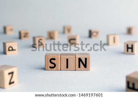 sin - word from wooden blocks with letters, to break a religious or moral law concept, random letters around, top view on wooden background Royalty-Free Stock Photo #1469197601