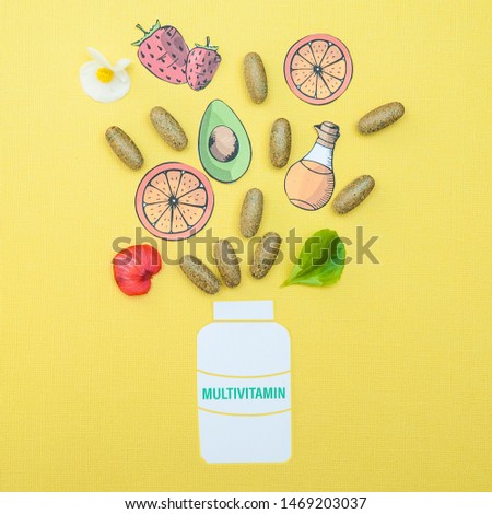 Concept multivitamins and supplements, a fountain of their capsules and useful products on a yellow background