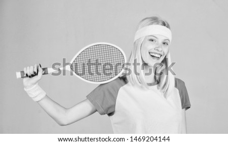 Athlete hold tennis racket in hand on grey background. Tennis sport and entertainment. Tennis club concept. Girl adorable blonde play tennis. Sport for maintaining health. Active leisure and hobby.