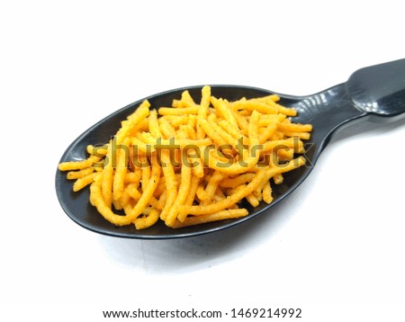 A picture of aloo bhujia on black spoon