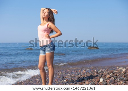 young beauty happy girl in summer by the sea