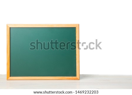 green blackboard on white table isolated on white background