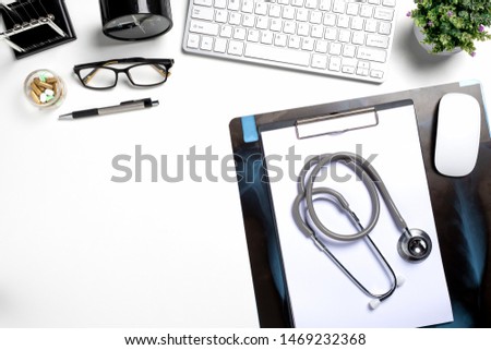 Mock up of doctors desktop with stethoscope and medical supplies.Top view