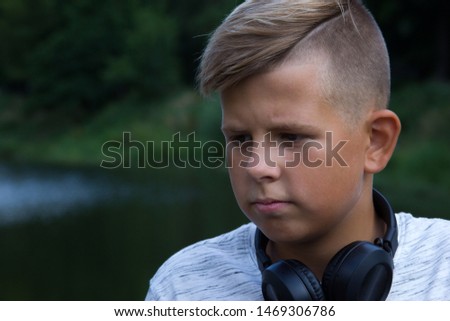 Beautiful portrait of a sad boy on the nature picture for text