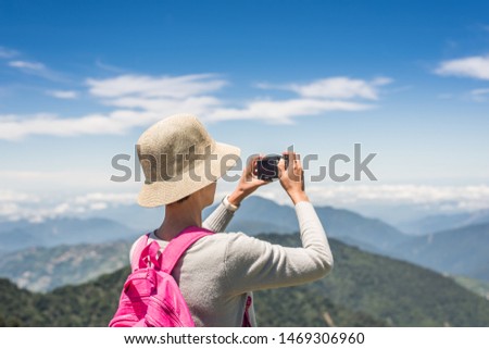 Asian climbing woman take pictures at Hehuan mountain, Taiwan