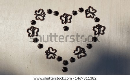 The contour of the heart, built of small details of the decor on a light background (abstraction)