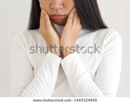 trigeminal neuralgia and temporomandibular joint and muscle disorder in asian woman, She use hand touching her cheek and symptoms fo pain and suffering on isoleted white background. Royalty-Free Stock Photo #1469324840