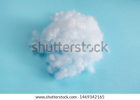 filler sintepon. white synthetic winterizer on blue background Royalty-Free Stock Photo #1469342165