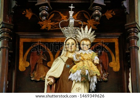 Statue of the image of Our Lady of Carmel, Nossa Senhora do Carmo, mother of God in the Catholic religion, decorated with flowers Royalty-Free Stock Photo #1469349626